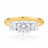 Gold ring with three diamond stones on a white background at LeGassick