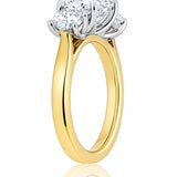 Gold ring with three diamond stones on a white background at LeGassick