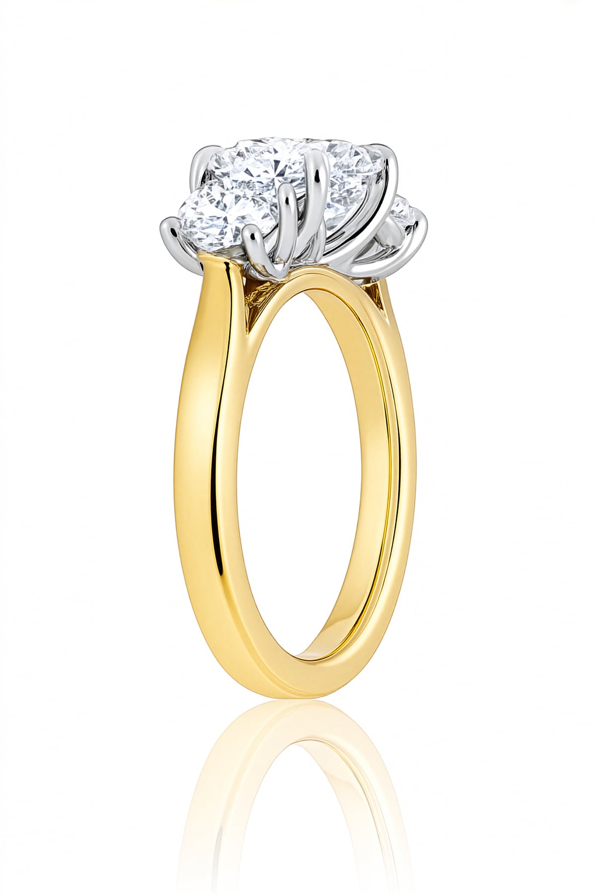 Gold ring with three diamond stones on a white background at LeGassick