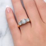 Gold ring with three diamond stones on a white background at LeGassick