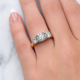 Gold ring with three diamond stones on a white background at LeGassick