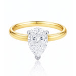 Gold ring with a pear-shaped lab grown diamond on a white background at LeGassick.