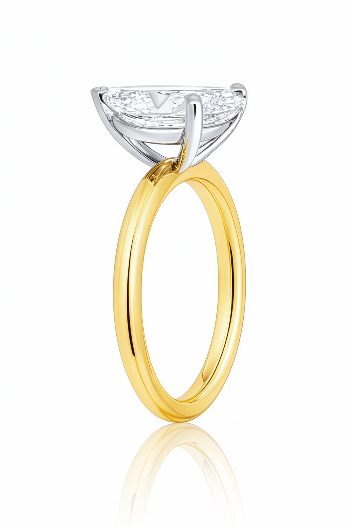 Gold ring with a pear-shaped lab grown diamond on a white background at LeGassick.