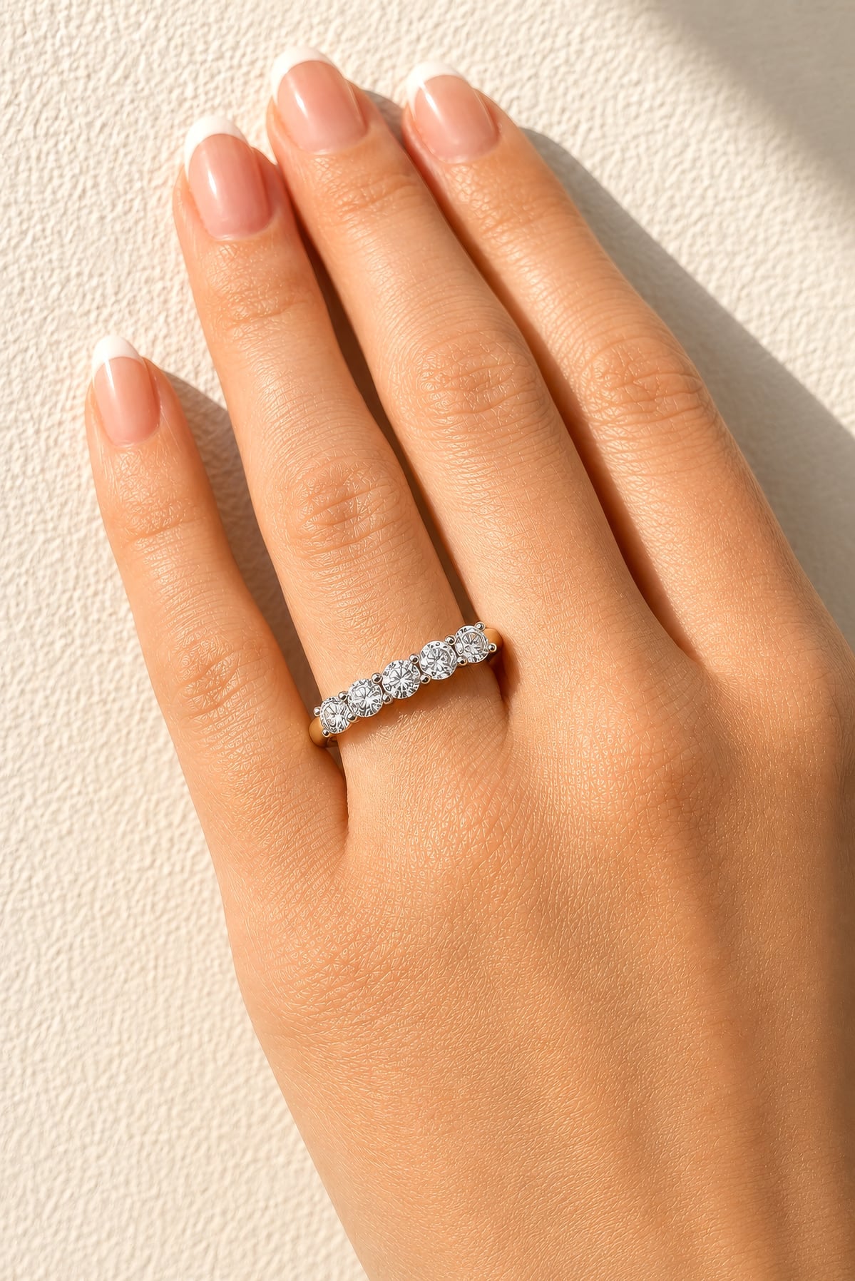 Gold ring with five lab created diamonds on a lady's hand at LeGassick, Gold Coast, Australia.
