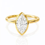 Gold ring with a marquise-shaped lab diamond on a white background