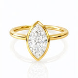 Gold ring with a marquise-shaped lab diamond on a white background