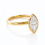 Gold ring with a marquise-shaped lab created diamond on a white background