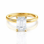 Gold ring with a large lab grown emerald cut diamond on a white background at LeGassick, Gold Coast, Australia.