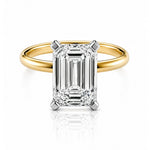 Gold ring with a large emerald-cut lab diamond on a white background
