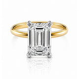Gold ring with a large emerald-cut lab diamond on a white background