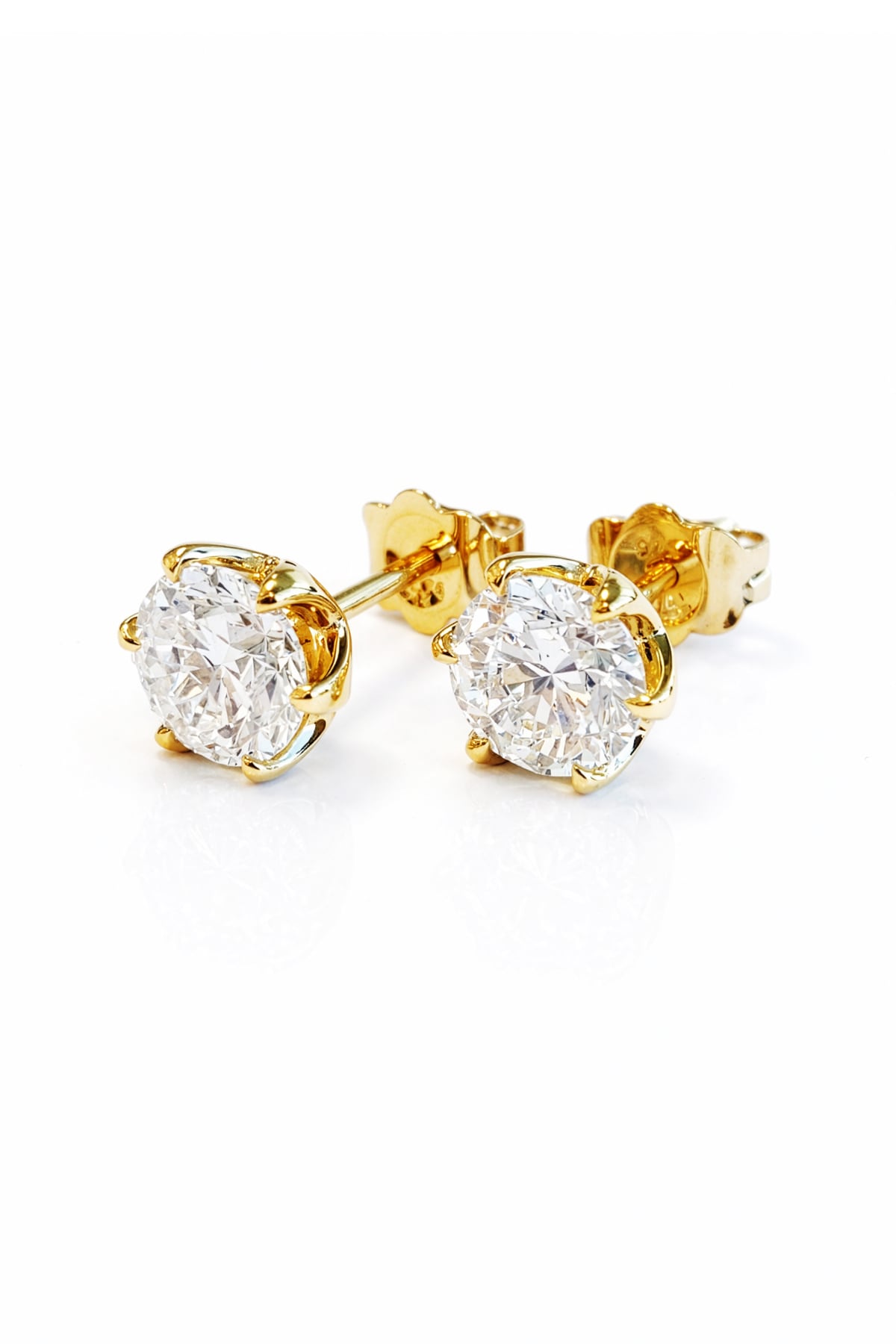 Gold lab diamond stud earrings on a white background
