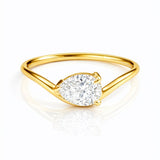 Gold ring with a pear cut lab grown diamond on a white background