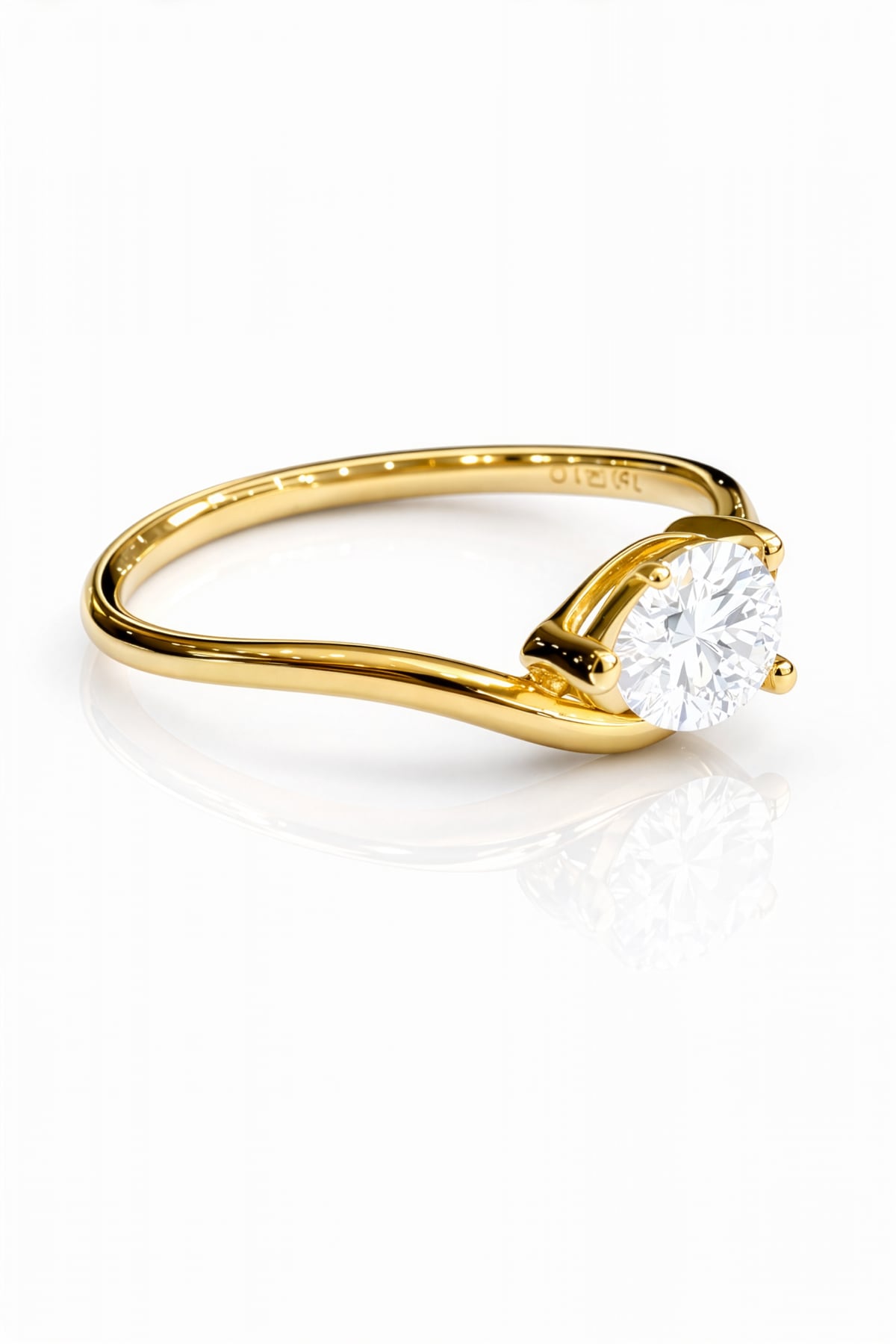 Gold ring with a pear cut lab grown diamond on a white background