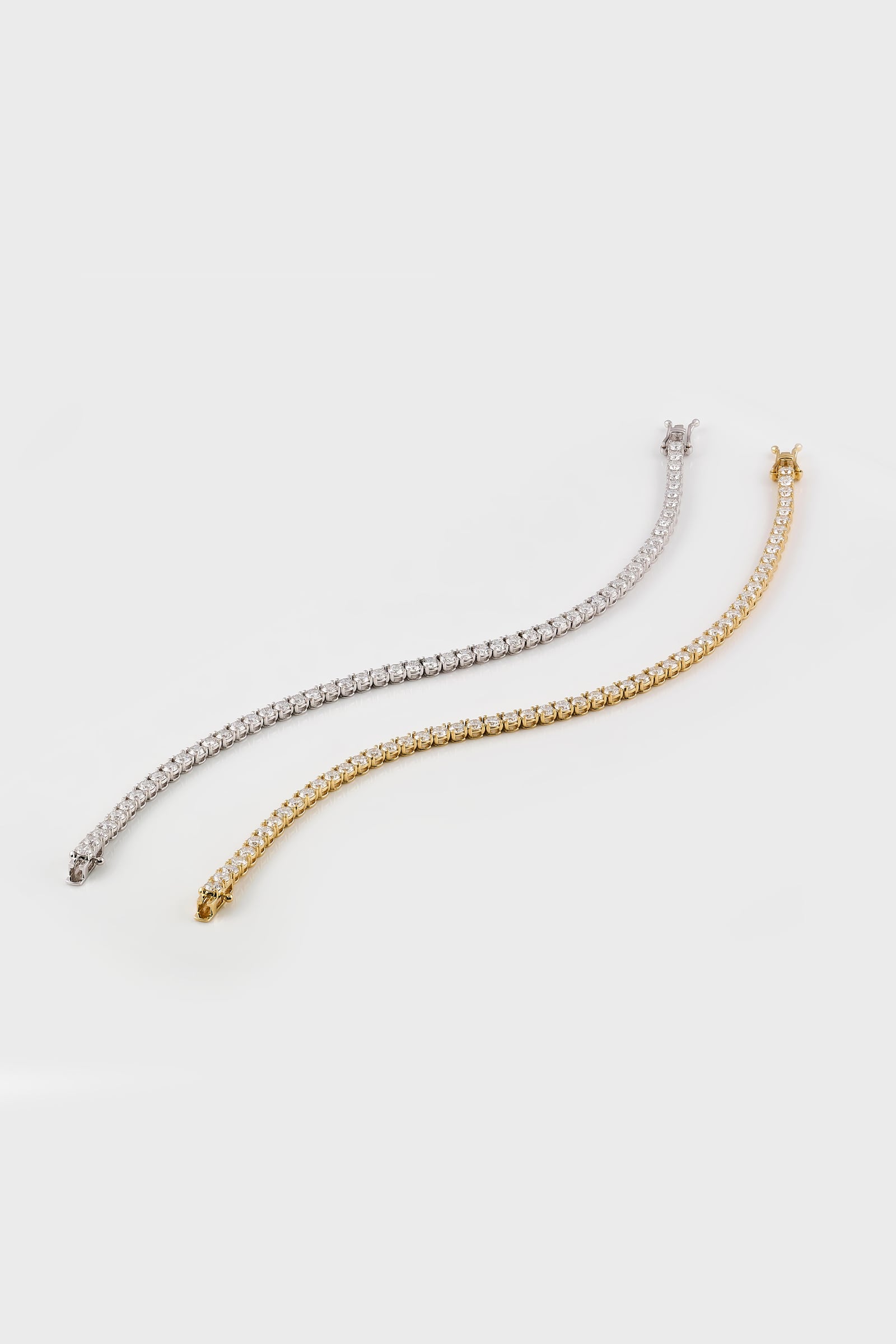 Yellow and white gold lab grown diamond tennis bracelets on a white background at LeGassick, Gold Coast, Australia.