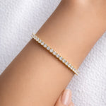 Yellow gold lab grown diamond tennis bracelet on a woman's wrist at LeGassick, Gold Coast, Australia.