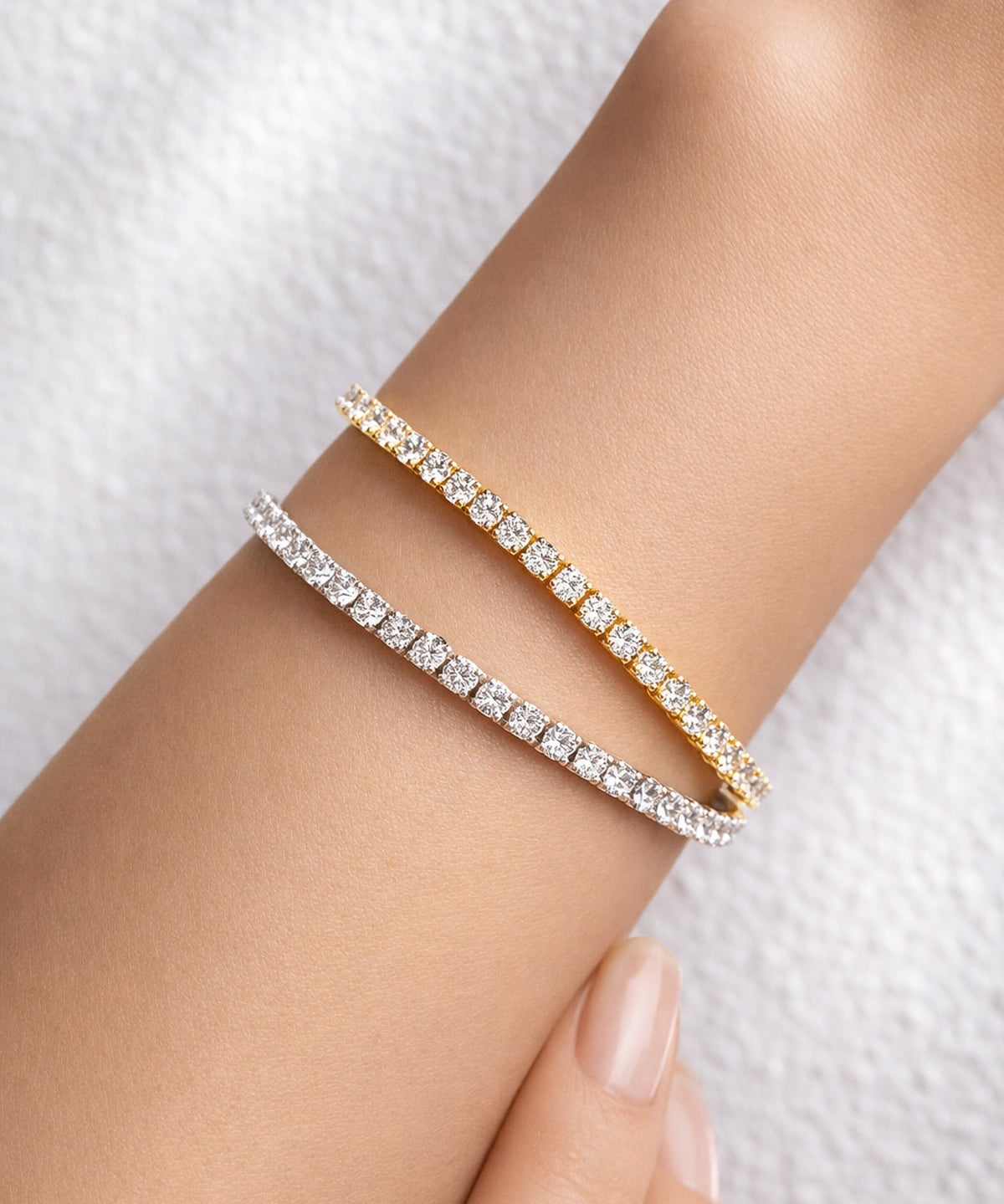 Yellow and white gold lab grown diamond tennis bracelets on a woman's wrist at LeGassick, Gold Coast, Australia.