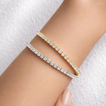 Yellow and white gold lab grown diamond tennis bracelets on a woman's wrist at LeGassick, Gold Coast, Australia.
