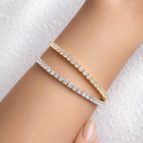 Yellow and white gold lab grown diamond tennis bracelets on a woman's wrist at LeGassick, Gold Coast, Australia.