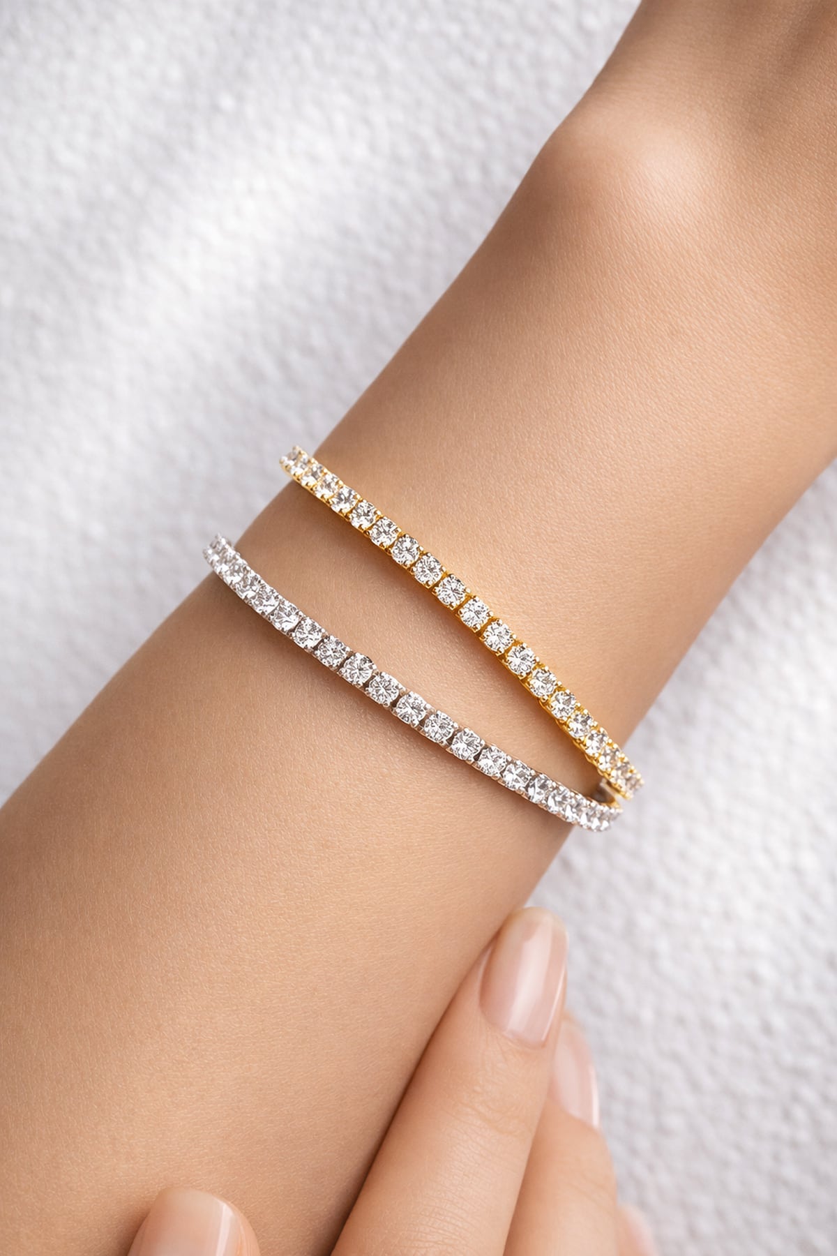 Yellow and white gold lab grown diamond tennis bracelets on a woman's wrist at LeGassick, Gold Coast, Australia.