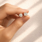 Hand holding a pair of lab diamond stud earrings against a soft background at LeGassick, Gold Coast, Australia.