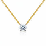 Gold necklace with a lab grown diamond pendant on a white background
