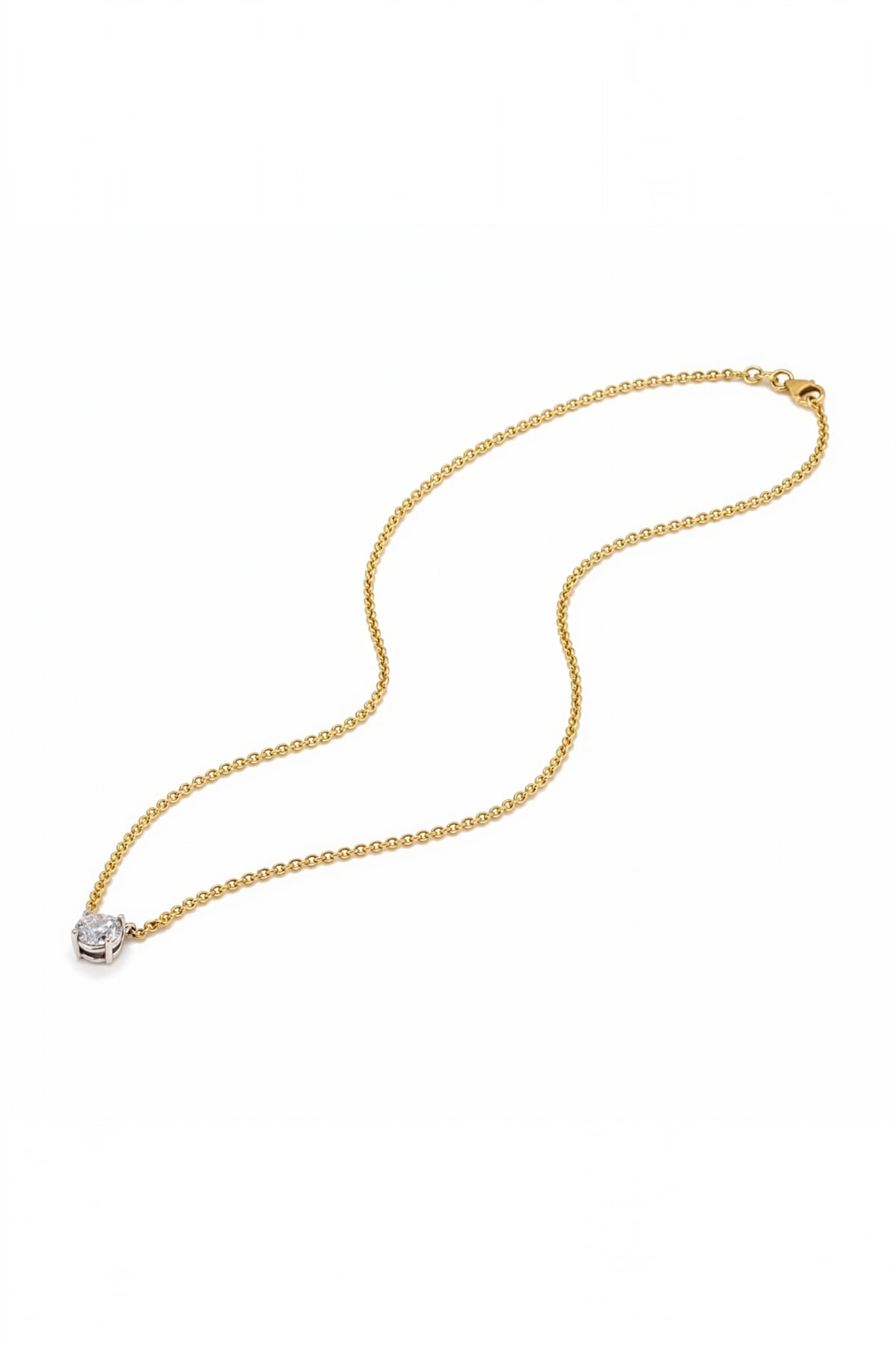 Gold necklace with a lab grown diamond pendant on a white background