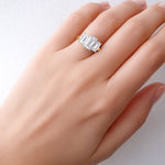 Lab created diamond ring on a hand against a light background