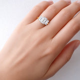 Lab created diamond ring on a hand against a light background