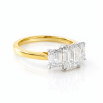 Gold ring with three lab diamond stones on a white background