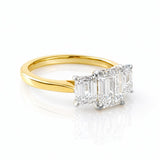 Gold ring with three lab diamond stones on a white background