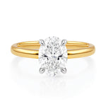Gold ring with a lab grown diamond on a white background at LeGassick.