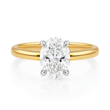 Gold ring with a lab grown diamond on a white background at LeGassick.