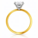 Gold ring with a lab grown diamond on a white background at LeGassick.