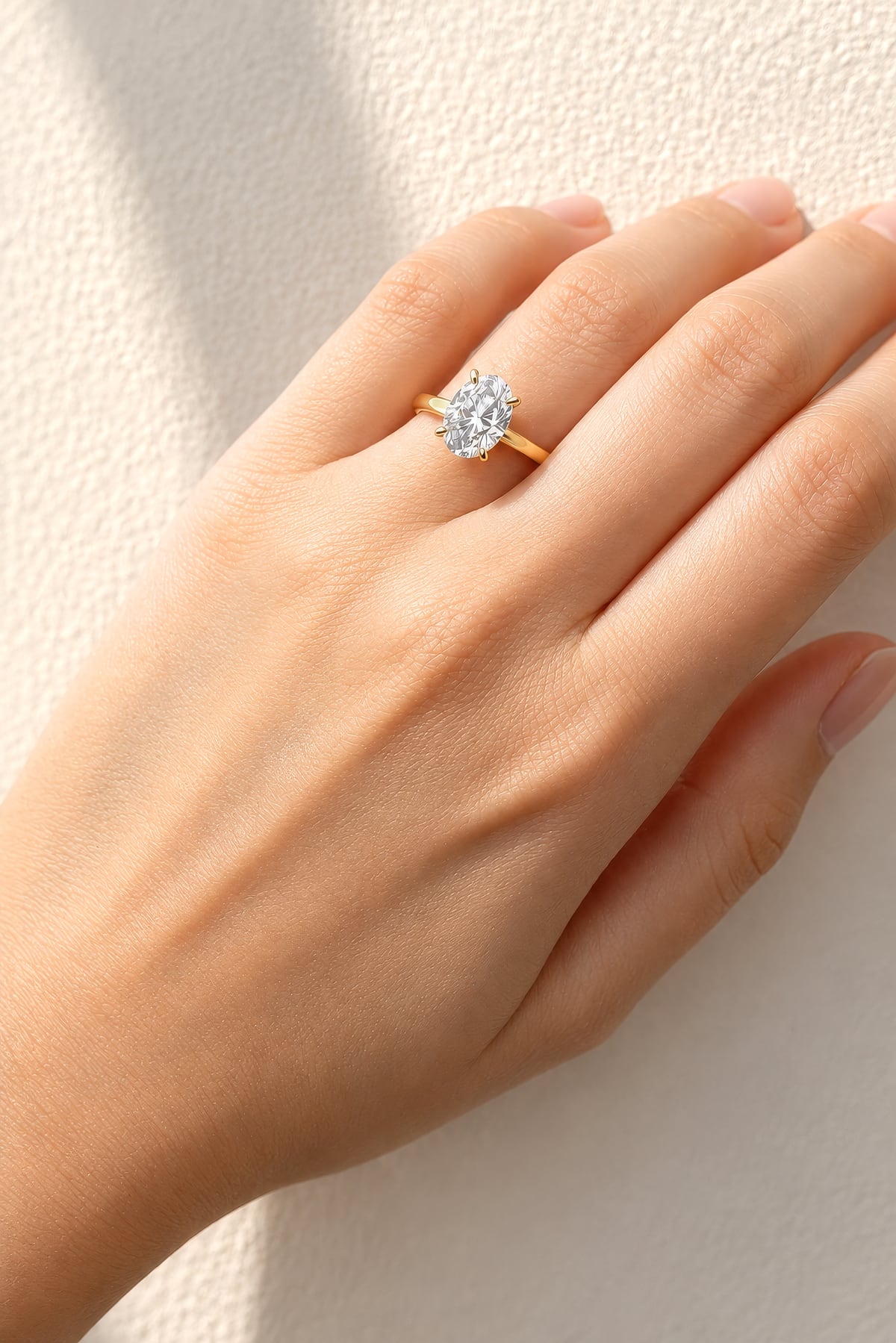 Gold ring with a lab diamond on a hand against a white background at LeGassick.