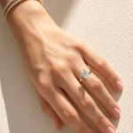 Hand wearing a lab diamond ring on a soft fabric background at LeGassick.
