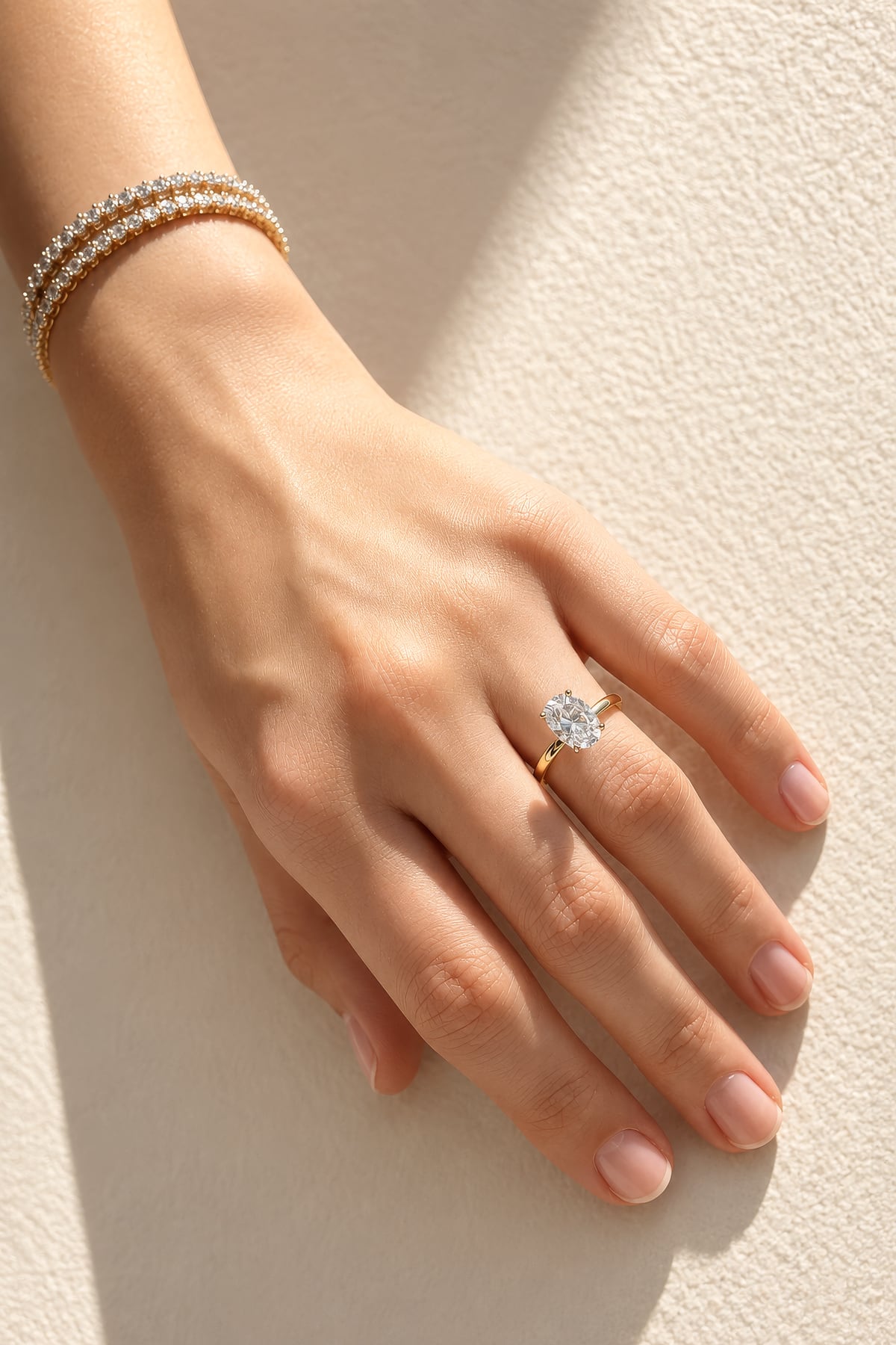 Hand wearing a lab diamond ring on a soft fabric background at LeGassick.