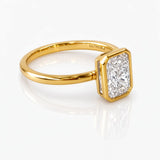 Gold ring with a rectangular diamond on a white background at LeGassick Gold Coast, Australia.