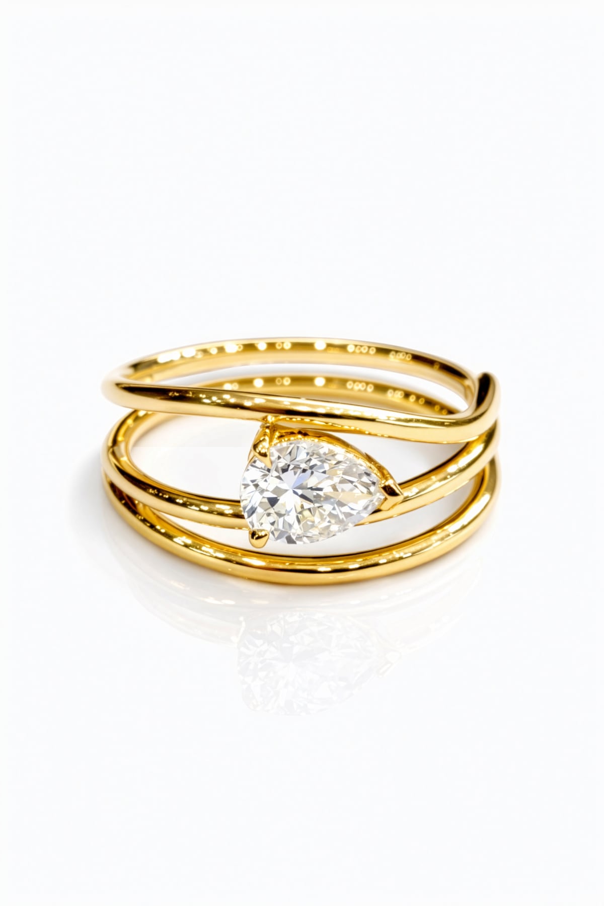 Gold ring with a lab grown pear diamond on a white background