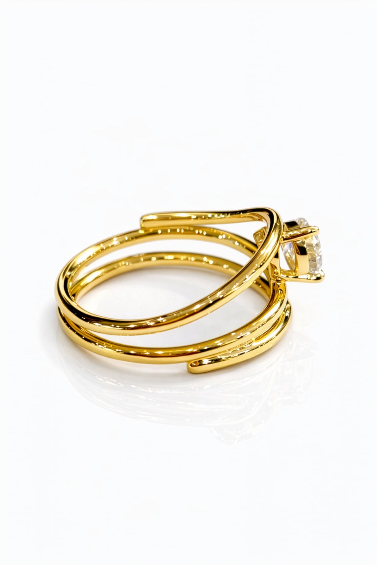 Gold ring with a lab grown pear diamond on a white background