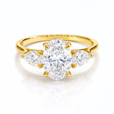 Gold ring with a large lab grown diamond and smaller diamonds on a white background