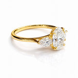 Gold ring with three lab grown diamonds on a white background