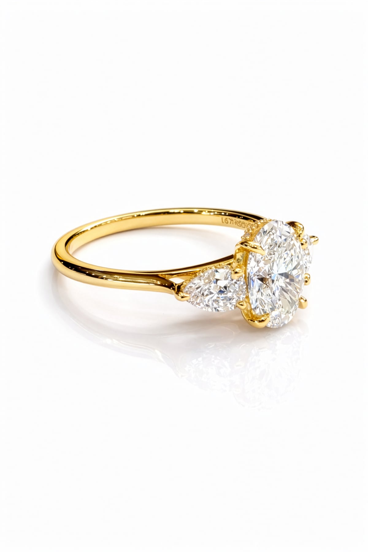 Gold ring with three lab grown diamonds on a white background