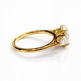 Gold ring with a large lab grown diamond and smaller diamonds on a white background
