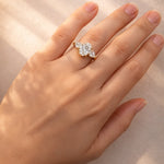 Hand wearing a lab grown diamond ring on a neutral background