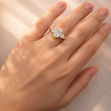 Hand wearing a lab grown diamond ring on a neutral background