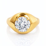 Gold ring with a large lab grown diamond on a white background