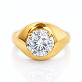 Gold ring with a large lab grown diamond on a white background