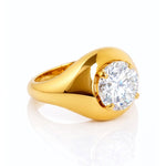 Gold ring with a large lab grown diamond on a white background