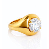 Gold ring with a large lab grown diamond on a white background