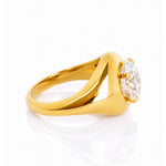 Gold ring with a large lab grown diamond on a white background